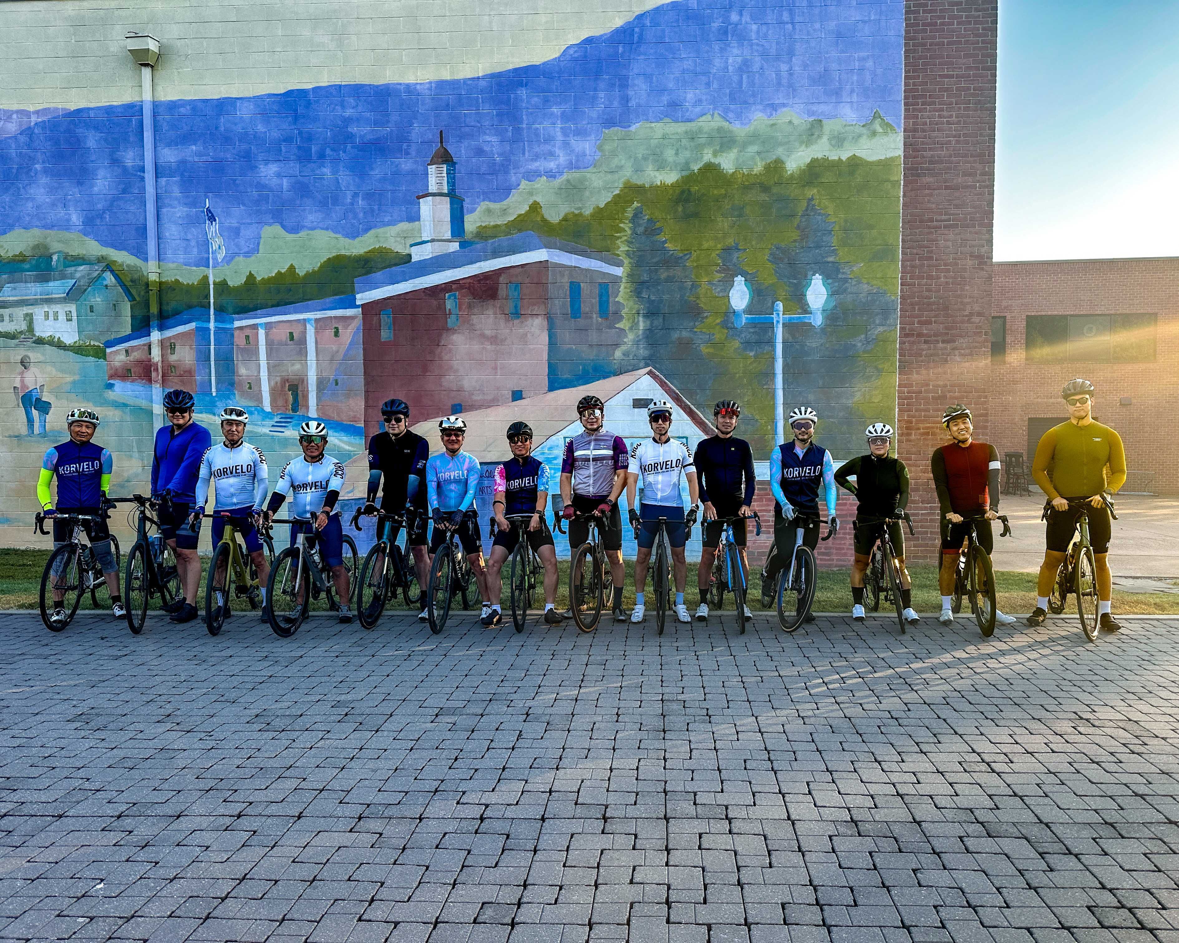 Korvelo group photo in front of a mural